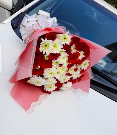 Celebrate love and harmony with a hand-wrapped bouquet of red roses and white blooms available for delivery across Kenya.