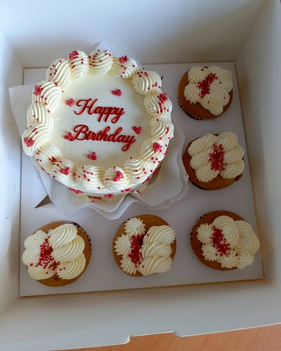 Order a beautifully decorated red and white birthday cake with matching cupcakes for same-day delivery in Nairobi.